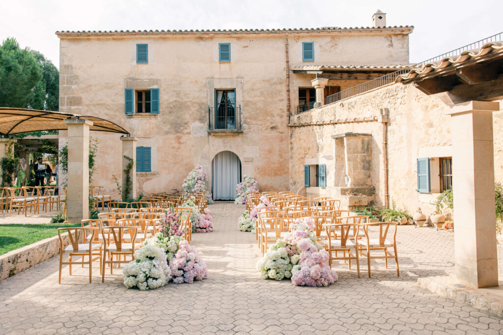 Elegant flower aisle arrangements for outdoor wedding ceremony in Mallorca
